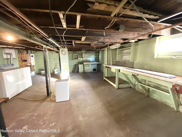 basement featuring washing machine and dryer and water heater