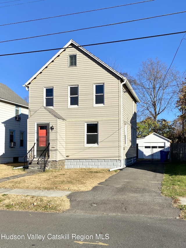 front of property featuring a garage and an outdoor structure