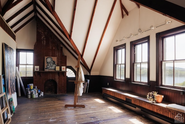 152 William St, Catskill, NY 12414 - living area featuring baseboard heating, hardwood / wood-style flooring, beamed ceiling, a fireplace, and wainscoting