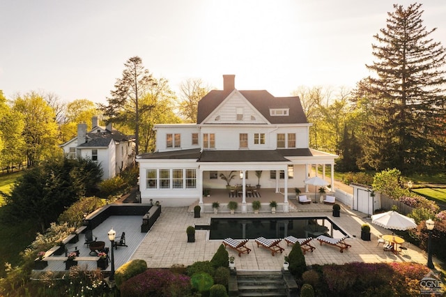 152 William St, Catskill, NY 12414 - rear view of house featuring outdoor dining space, an outdoor hangout area, fence, and a chimney