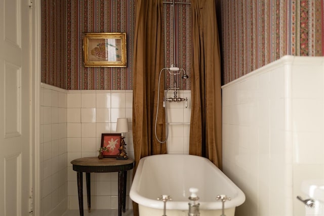 152 William St, Catskill, NY 12414 - bathroom with wallpapered walls, a wainscoted wall, a soaking tub, and tile walls