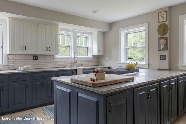 4170 Rte 9w, West Camp, NY 12477 - kitchen featuring healthy amount of natural light, white cabinets, decorative backsplash, and light tile patterned floors