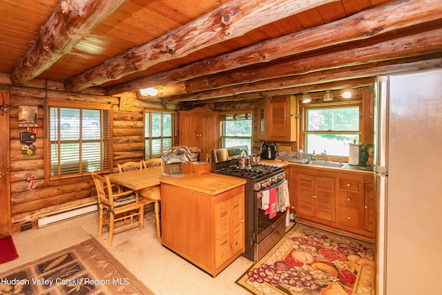 kitchen with beam ceiling, gas range, rustic walls, a baseboard radiator, and white refrigerator