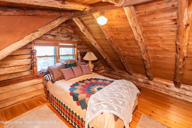 bedroom featuring lofted ceiling with beams, wood ceiling, and light hardwood / wood-style flooring