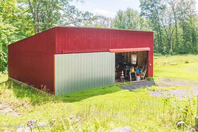 view of outdoor structure featuring a lawn