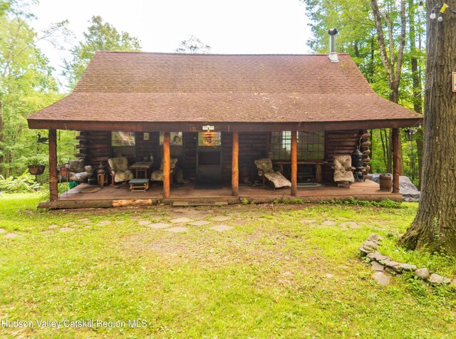 back of house featuring a lawn and a patio