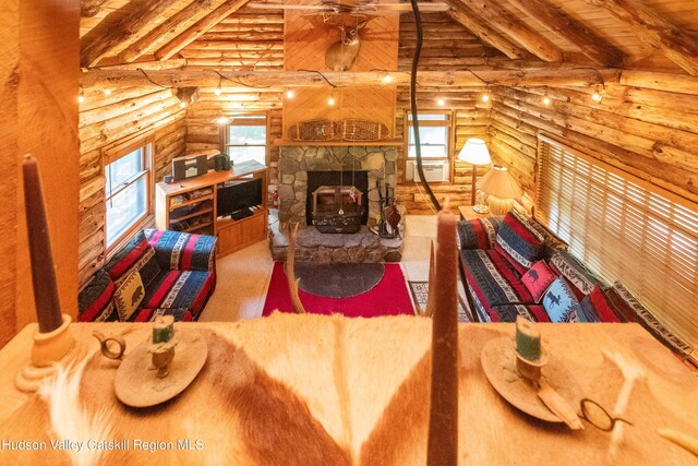 living room featuring beam ceiling, log walls, and wood ceiling