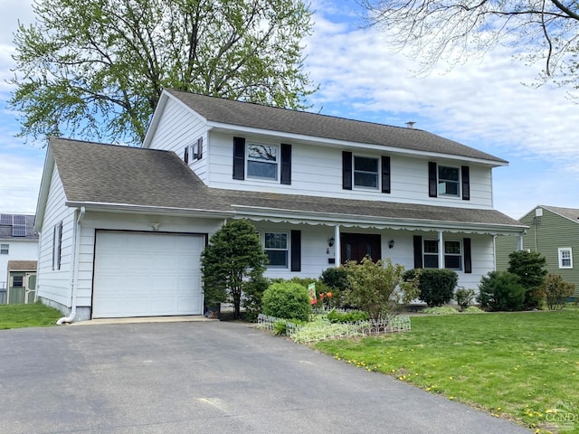 20 Joslen Pl, Hudson, NY 12534 - view of front facade with a garage, a front lawn, driveway, a porch, and roof with shingles