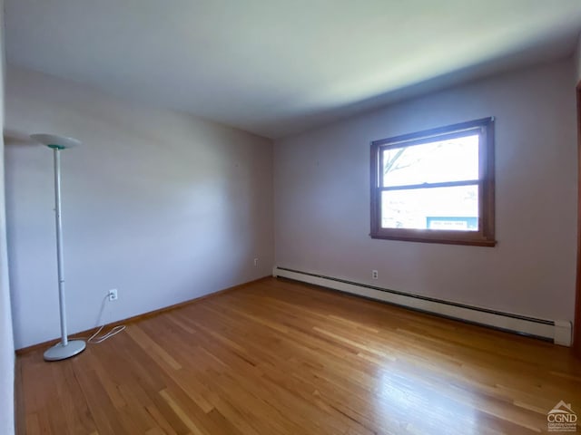 20 Joslen Pl, Hudson, NY 12534 - spare room featuring a baseboard radiator, wood finished floors, and baseboards