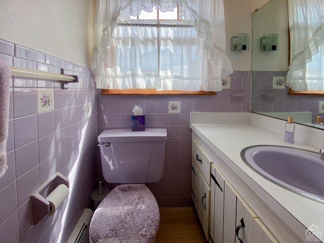 20 Joslen Pl, Hudson, NY 12534 - half bath featuring healthy amount of natural light, tile walls, vanity, toilet, and a baseboard radiator