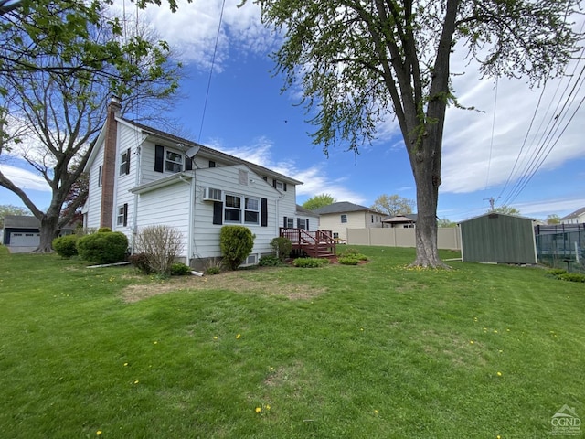 20 Joslen Pl, Hudson, NY 12534 - rear view of house with a chimney, a wooden deck, a storage unit, and an outbuilding
