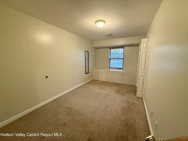 unfurnished bedroom featuring carpet floors, visible vents, and baseboards