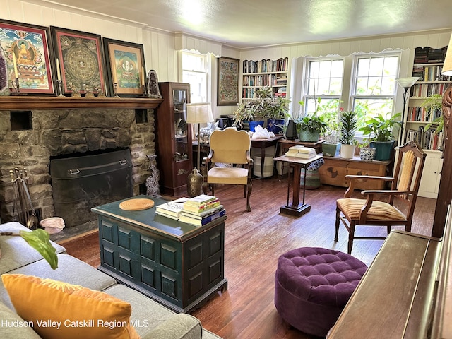174 Palentown Rd, Kerhonkson, NY 12446 - living area with wood finished floors, ornamental molding, a fireplace, and wood walls