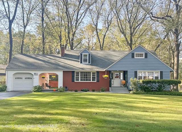 view of front of home featuring a garage and a front lawn