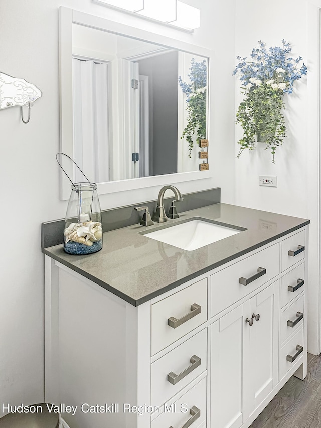 bathroom with vanity and hardwood / wood-style flooring