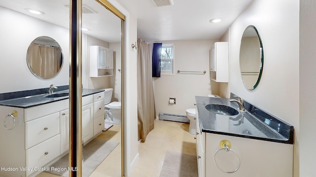 bathroom featuring baseboard heating, vanity, and toilet