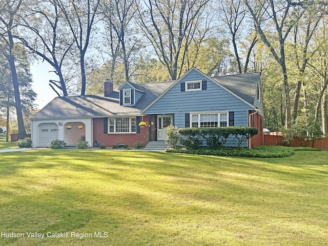 new england style home featuring a garage and a front yard