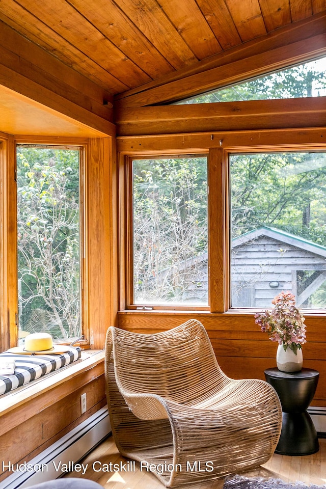 sunroom featuring baseboard heating, vaulted ceiling, plenty of natural light, and wooden ceiling