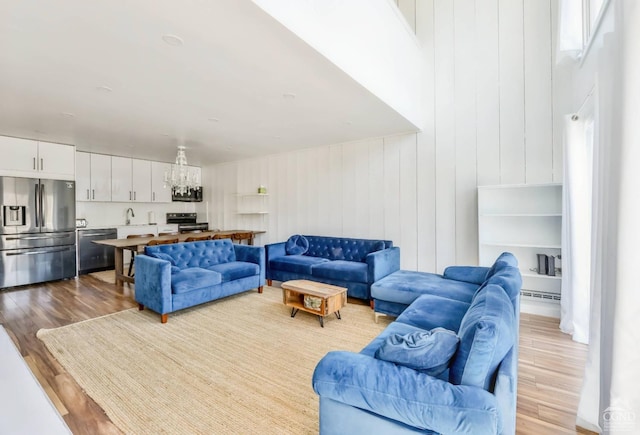 59 Scribner Hollow Rd # B-2, Hunter, NY 12442 - living room featuring wood finished floors and a chandelier