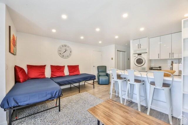 59 Scribner Hollow Rd # B-2, Hunter, NY 12442 - living room with light wood-type flooring, stacked washer / dryer, and recessed lighting