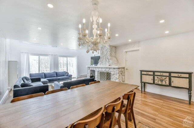59 Scribner Hollow Rd # B-2, Hunter, NY 12442 - dining area featuring recessed lighting, a chandelier, wood finished floors, baseboards, and a stone fireplace
