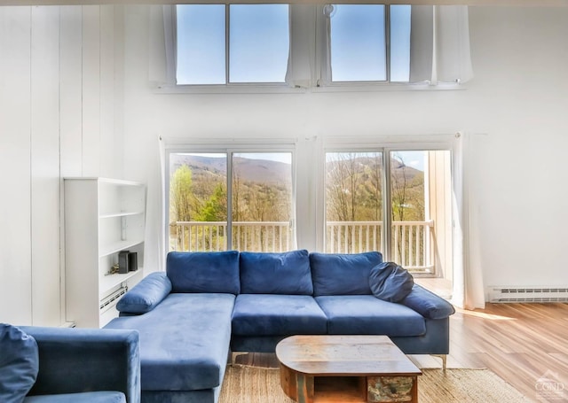 59 Scribner Hollow Rd # B-2, Hunter, NY 12442 - living area with a baseboard heating unit and wood finished floors