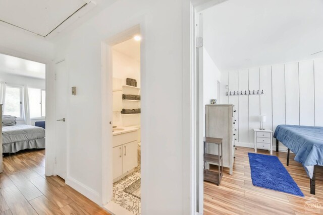59 Scribner Hollow Rd # B-2, Hunter, NY 12442 - bedroom with light wood-type flooring, attic access, and baseboards