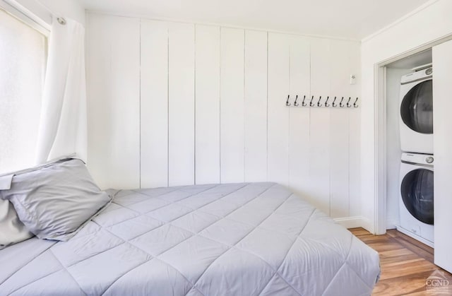 59 Scribner Hollow Rd # B-2, Hunter, NY 12442 - bedroom featuring estacked washer and dryer and light wood-style flooring