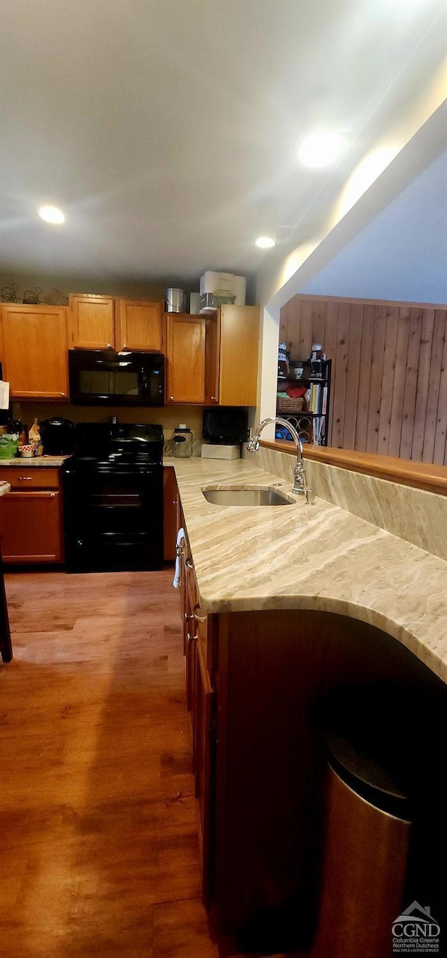 63 Windham Ridge Rd, Windham, NY 12496 - kitchen featuring black appliances, a sink, light countertops, light wood-type flooring, and brown cabinetry