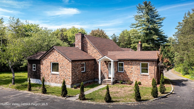 273 Round Top Rd, Germantown, NY 12526 - view of front facade featuring a chimney, brick siding, and a front yard