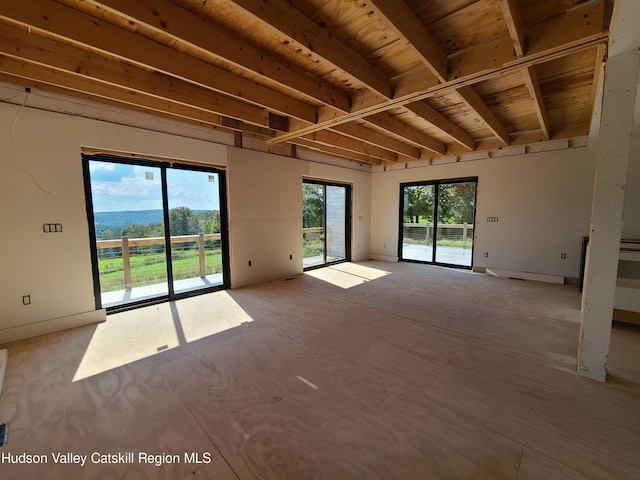 empty room featuring beamed ceiling and wooden ceiling