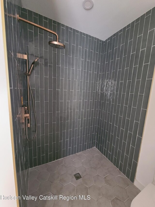 bathroom with a tile shower