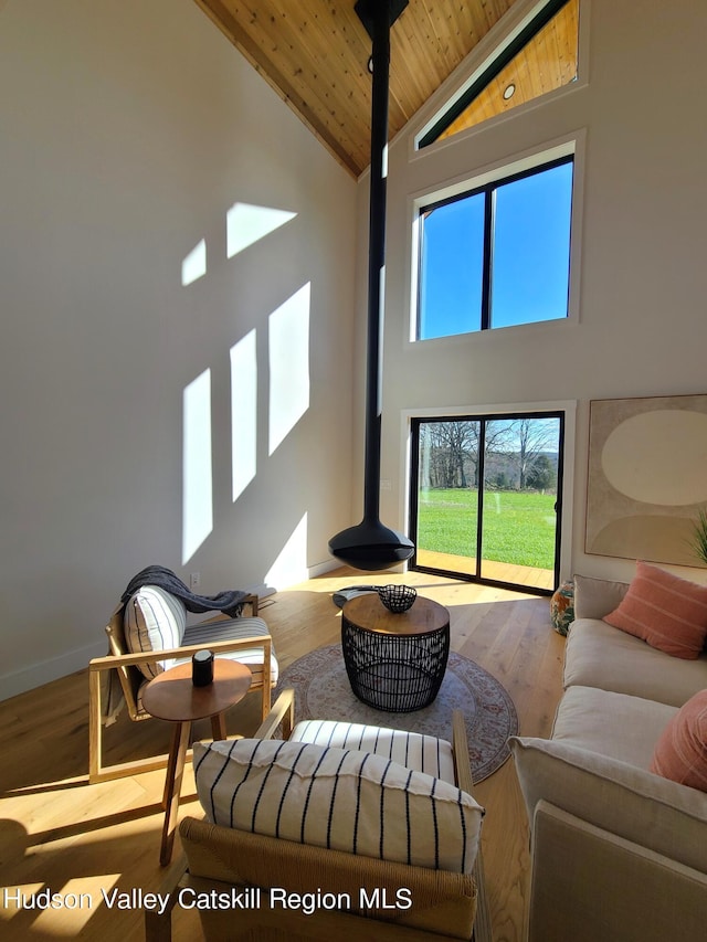 living room with hardwood / wood-style floors, high vaulted ceiling, and wooden ceiling