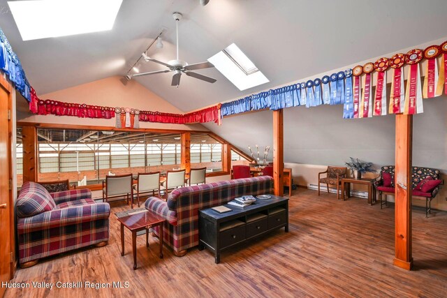 bedroom featuring hardwood / wood-style floors, track lighting, and vaulted ceiling