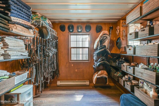 view of horse barn featuring a baseboard heating unit