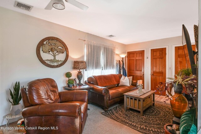 carpeted living room featuring ceiling fan