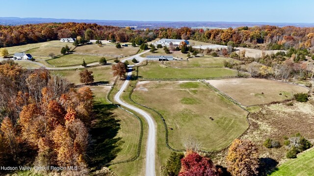 birds eye view of property with a rural view