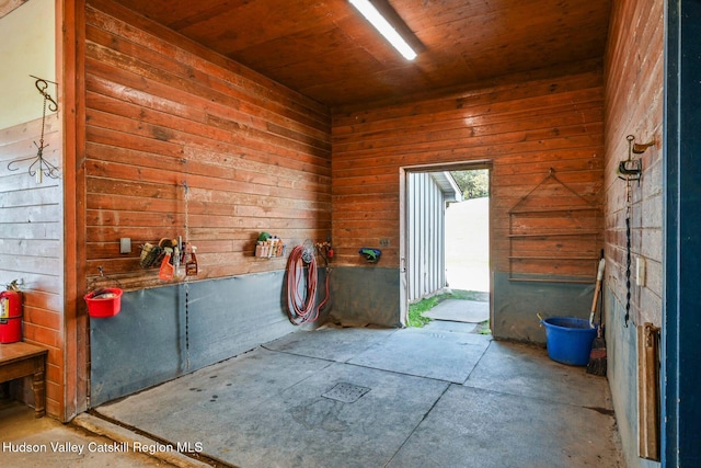 miscellaneous room featuring wooden walls and wood ceiling