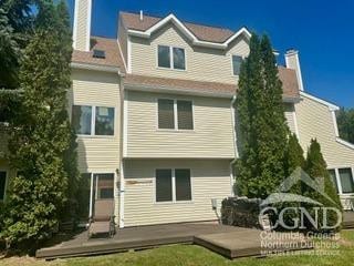 274 Brooksburgh Rd Unit 10, Windham, NY 12496 - rear view of house featuring a lawn, a wooden deck, and a chimney