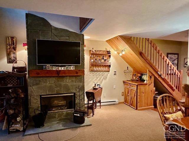 274 Brooksburgh Rd Unit 10, Windham, NY 12496 - carpeted living room with a stone fireplace and stairway
