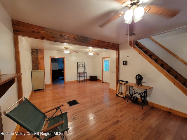 2457 State Route 82, Ancram, NY 12502 - living area with a ceiling fan, light wood-style floors, baseboards, and beamed ceiling