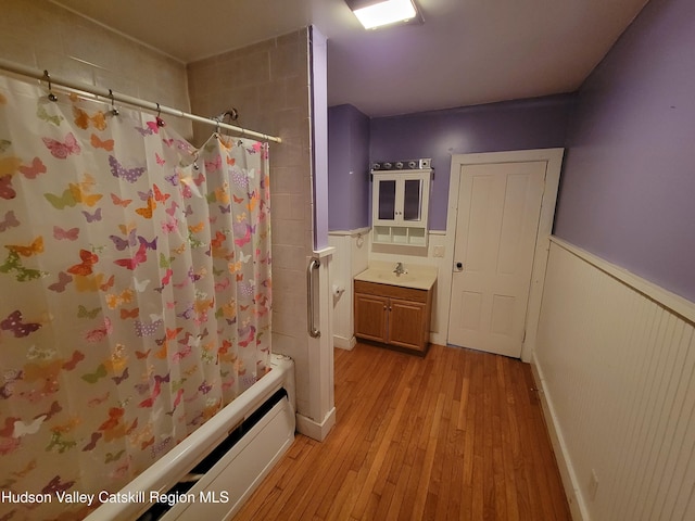 2457 State Route 82, Ancram, NY 12502 - full bath with wainscoting, shower / bath combo, hardwood / wood-style floors, a baseboard radiator, and vanity