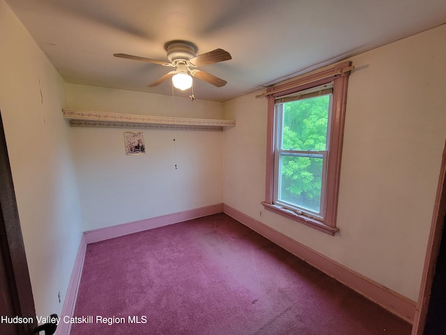 2457 State Route 82, Ancram, NY 12502 - spare room with dark colored carpet, a ceiling fan, and baseboards