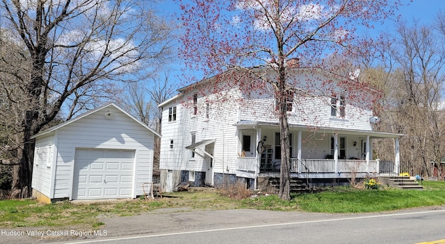 2457 State Route 82, Ancram, NY 12502 - view of front of house with covered porch, a garage, and an outdoor structure
