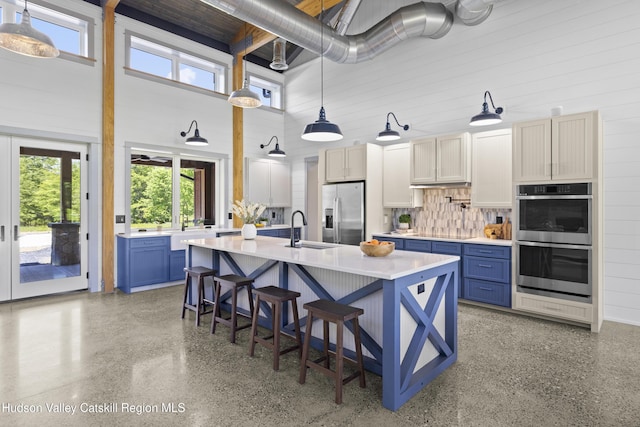 1248 Albany Post Rd, Gardiner, NY 12525 - kitchen with appliances with stainless steel finishes, a sink, a high ceiling, blue cabinets, and light countertops