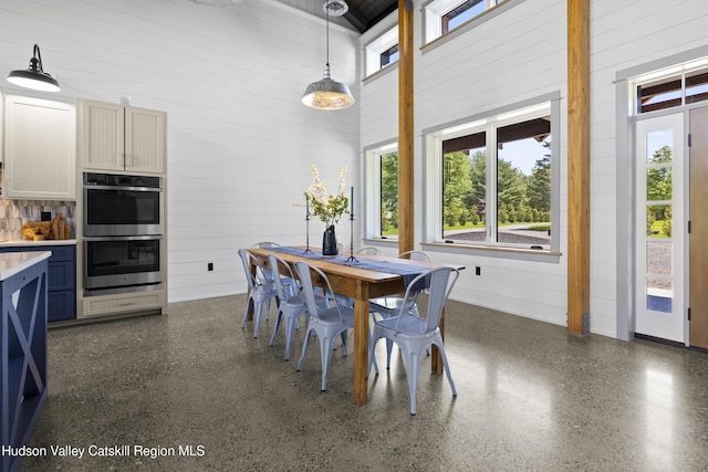 1248 Albany Post Rd, Gardiner, NY 12525 - dining room featuring wood walls and light speckled floor
