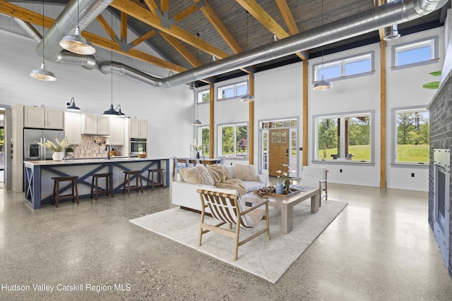 1248 Albany Post Rd, Gardiner, NY 12525 - living area with a high ceiling, speckled floor, and beamed ceiling