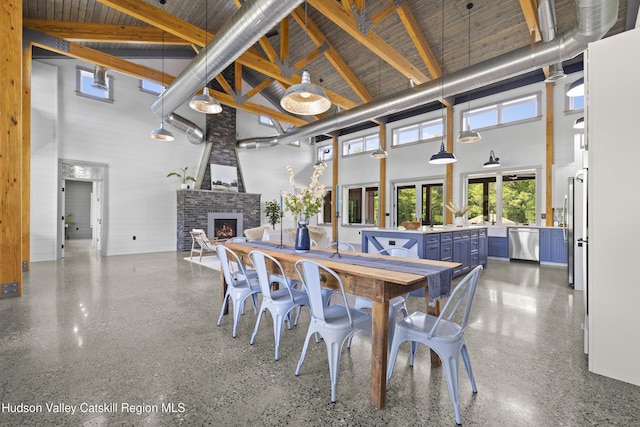1248 Albany Post Rd, Gardiner, NY 12525 - dining space with a high ceiling, a fireplace, and speckle patterned floor