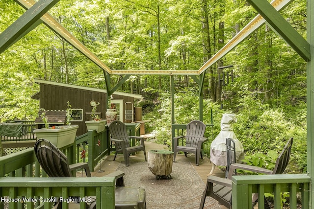 sunroom / solarium featuring a wooded view