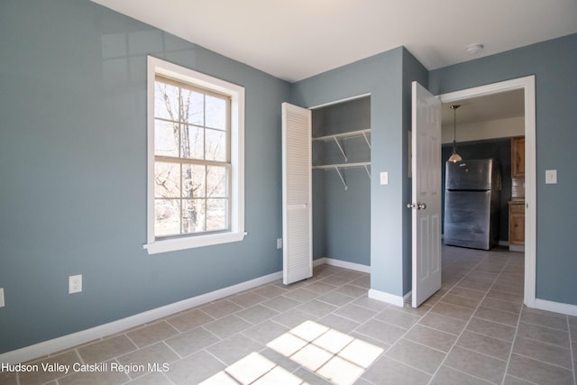 7180 Rte 209, Wawarsing, NY 12489 - unfurnished bedroom with freestanding refrigerator, tile patterned flooring, and a closet